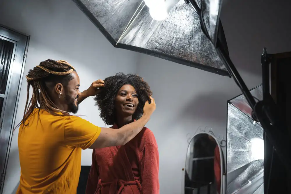 une modèle se fait coiffer lors d'un shooting photo